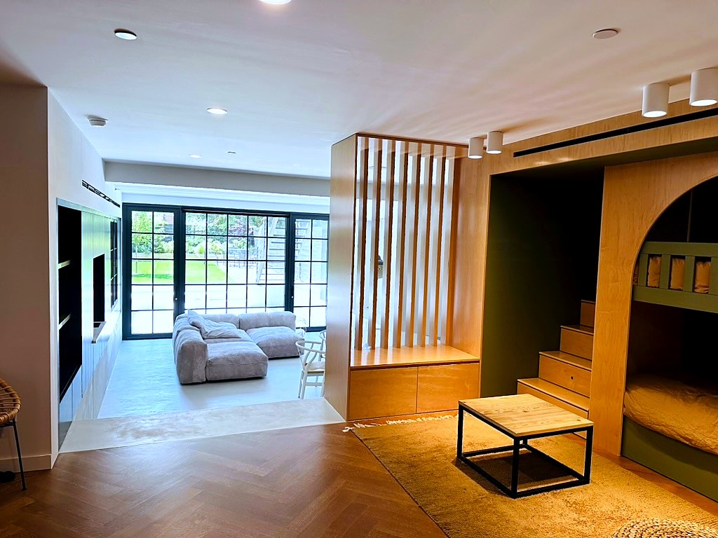 Cobble Hill Townhouse — great room with bunk-bed millwork archway and steel-framed garden doors