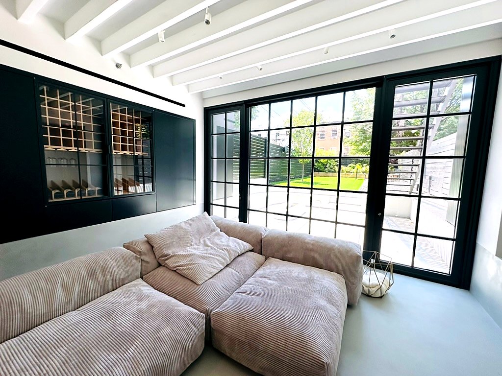 Cobble Hill Townhouse — microtopping floors, custom oak bunk-bed millwork, and steel-framed garden doors