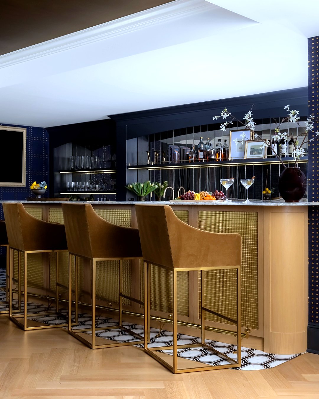 Purchase, NY Estate — home bar with marble counter, brass-caned stools, and mirrored back-bar against navy grasscloth